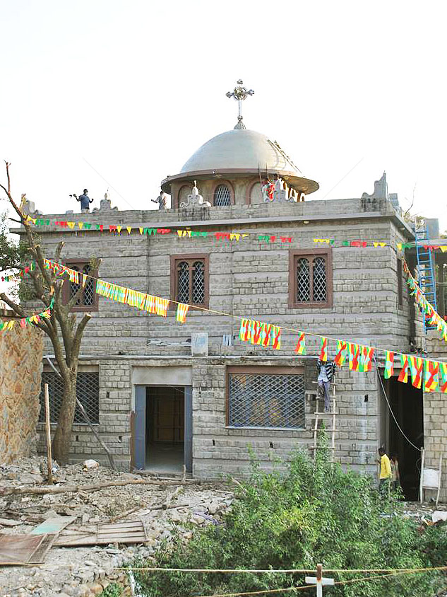 Workmen finish exterior of New Chapel of the Tablet in Aksum Ethiopia