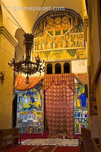 caption: Paintings in the old church of 'St Mary of Zion' and the covered entrance to the inner chapel.