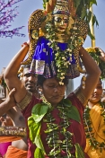 Woman with skewer through her mouth carries statue of Lord Murugan