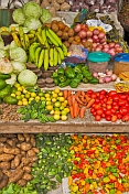 Assorted fruit and vegetables for sale on market stall.