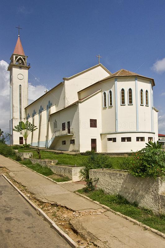 The white stucco Roman Catholic church.
