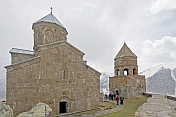 A party of trekkers visit the Tsminda Sameba Monastery, in the mountains overlooking Kazbegi.