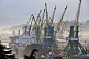 Ships wait for unloading amidst a forest of cranes at the docks.
