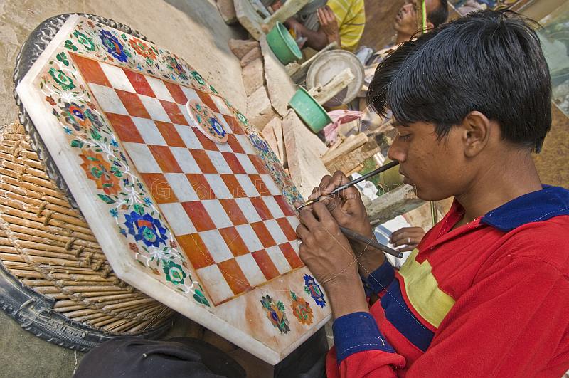 Young craftsman creating a chess board from inlaid-marble, or Pietra-Dura.