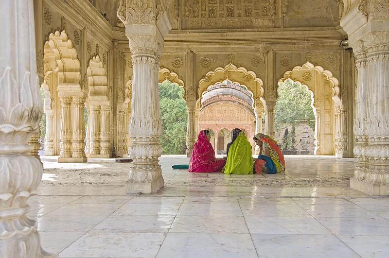 Three Indian ladies sit in the Cenotaph of Maharaja Bakhtawar Singh.