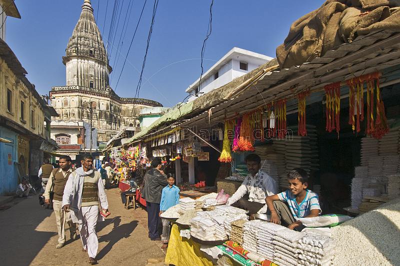 Prasad sellers wait for pilgrims on their way to visit the Raj Duar Temple.