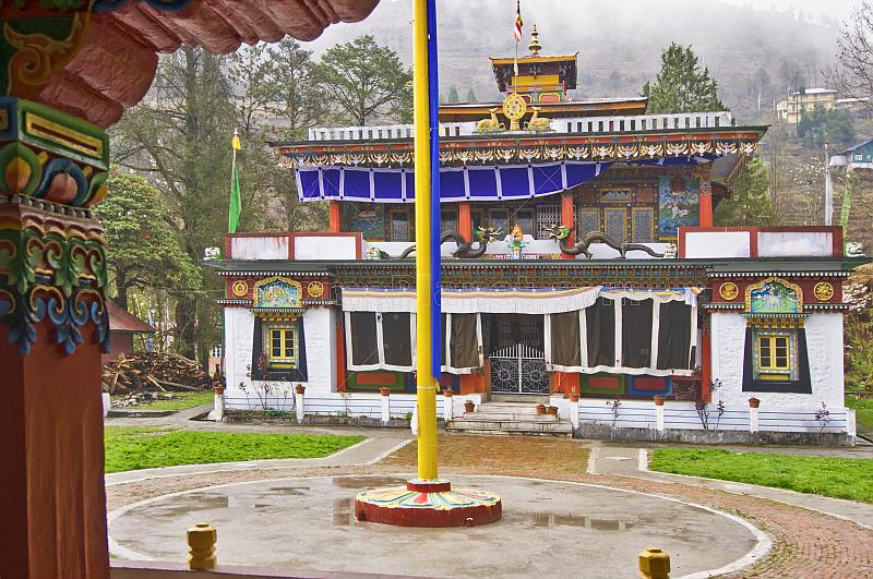 Flagpole and frontage of a Buddhist monastery.