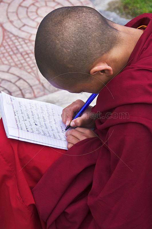 Young Buddhist monk does his homework at the Rumtek Monastery.
