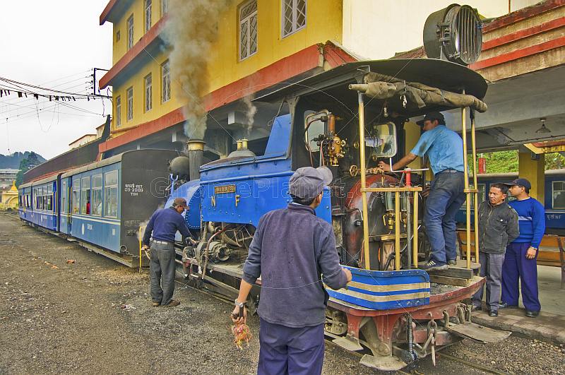 Engineers struggle to get a steam engine on the Darjeeling Himalayan Railway ready for service.