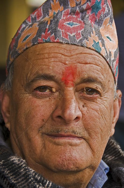 Mountain man in traditional Gorkhaland hat.