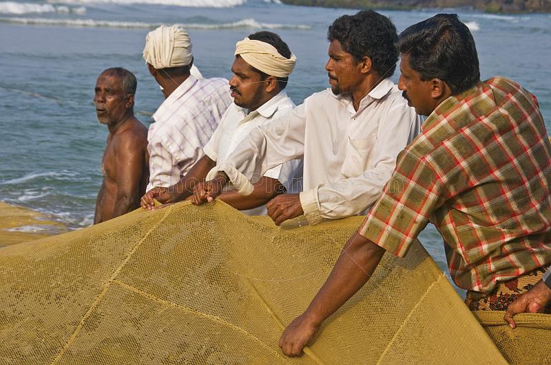 Fishermen haul in on their nets.