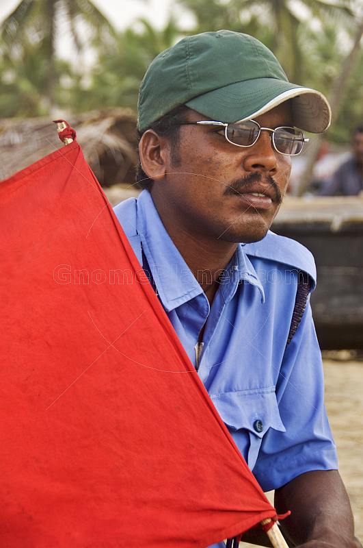 Indian lifeguard with red flag.