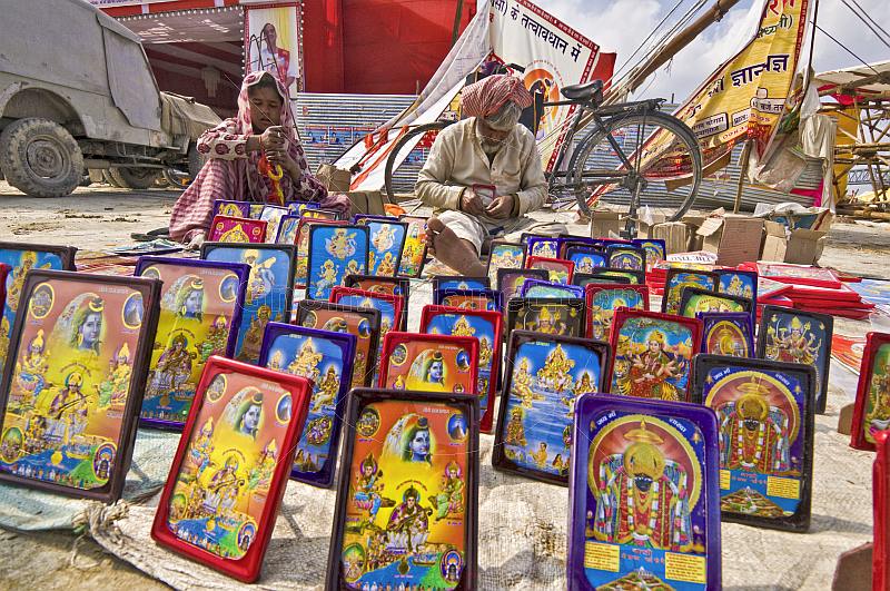 Collection of framed religious Hindu paintings for sale at Kumbh Mela festival.