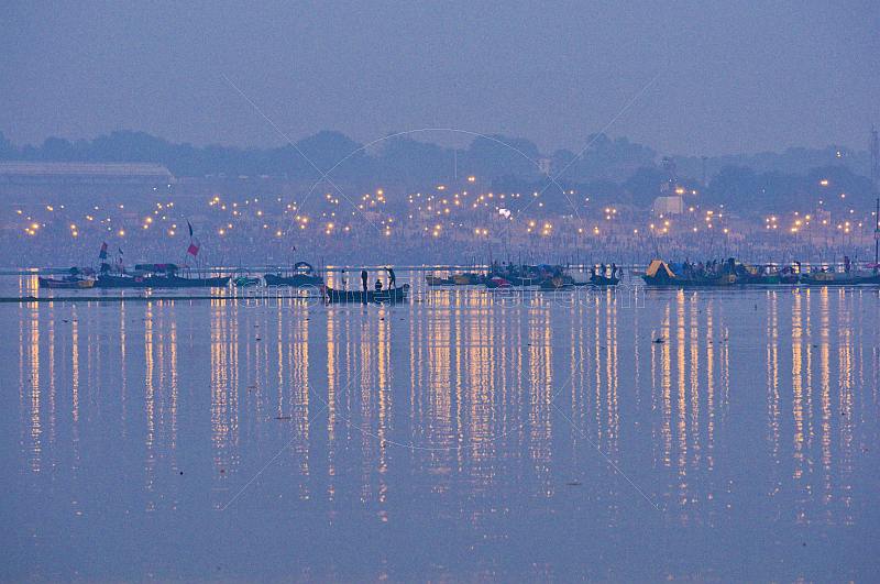 Rowing boats take pilgrims to visit Ganges Yamuna river Sangam before dawn.