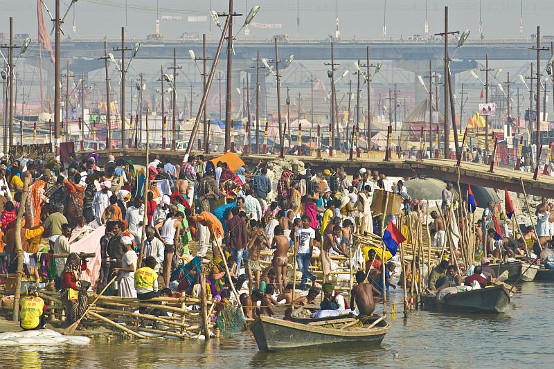Crowded bathing ghats on the fast-flowing Ganges River at the Kumbh Mela festival.