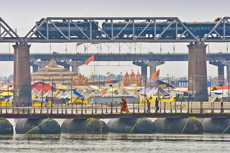 Road rail and pontoon foot bridges cross the Ganges River at Kumbh Mela festival site.