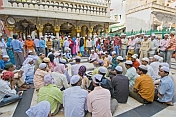 Worshippers in the marble courtyard of the Dargah of Hazarat Nizamuddin.