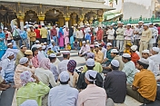 Worshippers in the marble courtyard of the Dargah of Hazarat Nizamuddin.