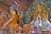 Buddhist statues in colorful robes at the Bhutanese Temple.