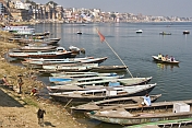 Rowing boats lined up along the banks of the Ganges River.