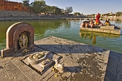 Hindu priests hold a ceremony on a puja platform in the Shipra River, the site of the 12-yearly Kumbh Mela.