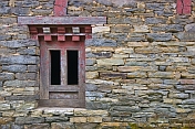 Dry-stone wall and wooden window frame at the Pemayangtse Monastery.