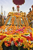Two Holy Men On Roof Of Flower Decorated Jeep