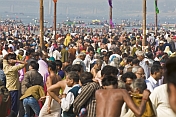 Huge crowds struggle to find space to change after sacred dip in the Yamuna river.