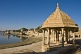 Image of Carved sandstone temples along the edge of the Gadi Sagar built 1367 by Maharaja Gadsi Singh.