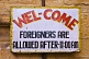 Welcome sign - Foreigners Are Allowed After 11:00 AM.