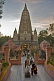 Image of Pilgrims and monks at the entrance to the Mahabodhi Temple at sunset.
