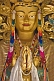 Buddhist statue in colorful robes and jewels at the Bhutanese Temple.