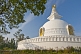 Image of The Japanese-built Nipponzan Myohoji Stupa, on top of Ratnagiri Hill, has four golden statues of the Buddha.