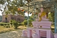 Image of A pink statue of the Buddha outside the Thai Buddhist Temple at Sarnath.