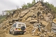 Image of A Mahindra 4wd SUV creeps with care past a dangerous landslide on the road north of Gangtok.