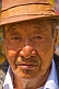 Image of Elderly Buddhist man in hat and earing.