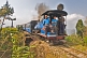 Image of A steam train on the Himalayan Mountain Railway crosses over its own lines at the Batasia Loop.
