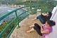 Two young Indian women enjoy the view of Kovalam Beach from the top of the Vizhinjam Lighthouse tower.