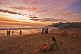 Image of Indian bathers on Hawaa Beach watch the last rays of sunset.