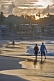 Couple walk along Lighthouse Beach at dawn.