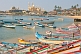 Boats at anchor in Vizhinjam fishing harbour, with mosque in the distance.