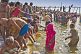 Mass crowds of Hindu pilgrims struggle to bathe in shallows of Ganges river Sangam.