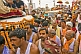 Mass crowds of Hindu Holy Men and jeeps join in the Kumbh Mela procession.