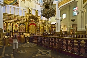 A young girl takes a photograph of icons in the Zenkov Cathedral.