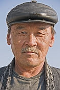 Kazakh man in black leather hat.