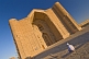 Image of Muslim man sits outside of the Yasaui Mausoleum, waiting for the doors to open.