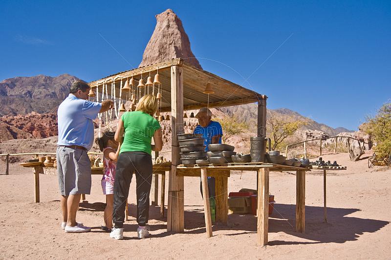 Visitors view a roadside souvenir stall at the Quebrada de las Conchas.