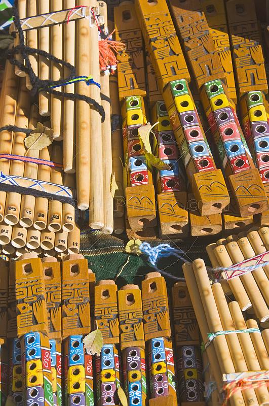 Pan pipes and wooden whistles for sale on a souvenir stall.