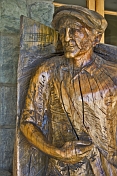 Life-sized wood carving of old man outside of the Civic Centre.
