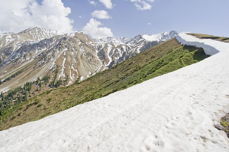 A well-defined snowline marks the Altyn Arashan Mountains in Sarycat Ertas Nature Reserve.